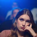 close-up portrait of a woman feeling disappointed and bored while watching a movie at the cinema