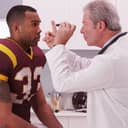 Rugby player being examined by a doctor