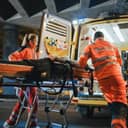 Paramedics rushing a patients on a stretcher to an ambulance