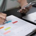 person planning with a colorful planner pen and smartphone