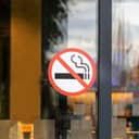 "No Smoking" sticker on a glass door