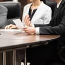 A closeup view of people in a meeting