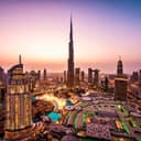 View of Dubai skyline at night. City lights popping. Dancing fountain display. Luxury travel holiday concept