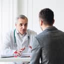 Senior doctor consults young patient