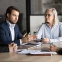 young male project manager confidently discussing work plans and strategies with colleagues during a meeting in the office