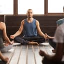 An instructor and his class meditating