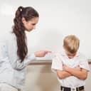 Young boy being scolded by a woman