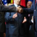 close-up of two politicians shaking hands after coming to an agreement