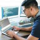 Man writing computer code on laptop