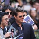 Tom Cruise being photographed with fans