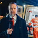 Reporter at the scene talking to the camera