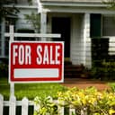 For sale sign outside a family house