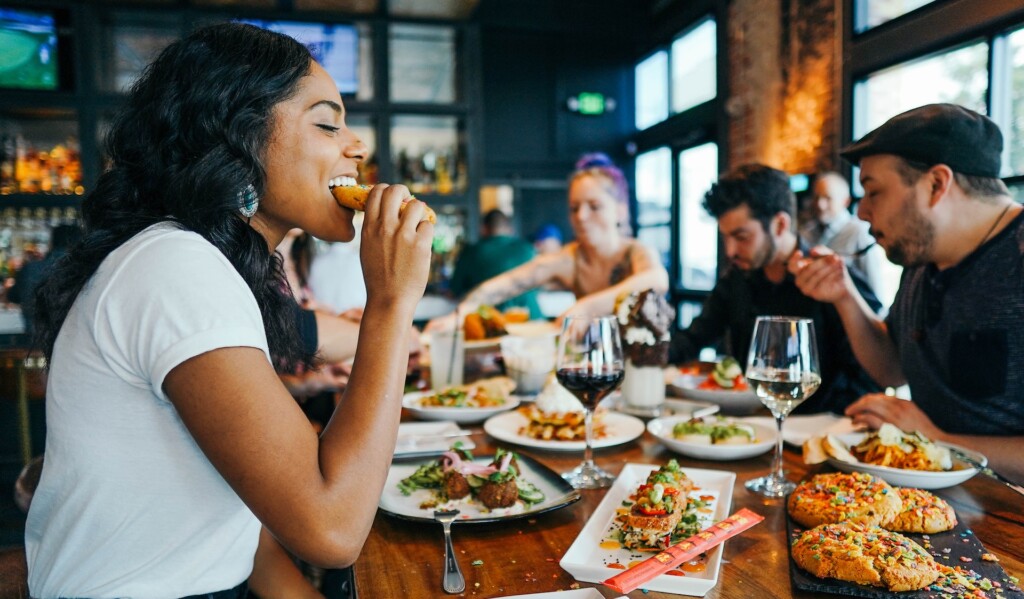 A woman eating a very delicious and satisfying meal in a restaurant