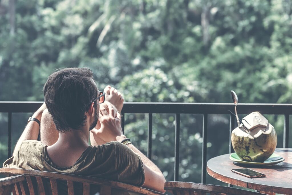 A man putting his feet up and relaxing on his balcony