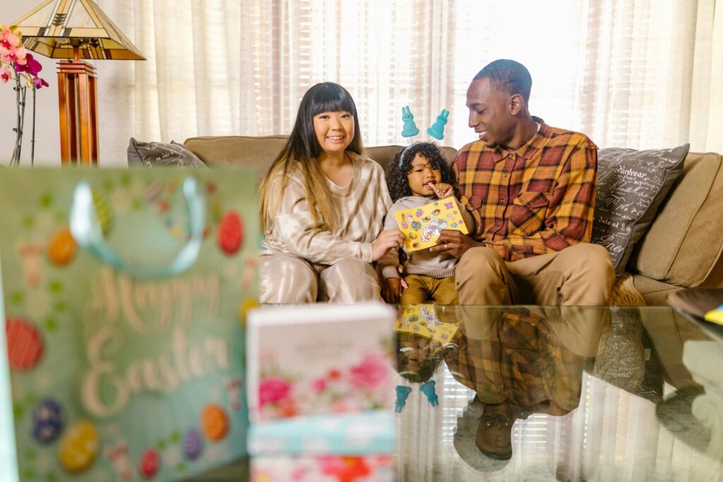 Parents celebrating a holiday at home with their young daughter