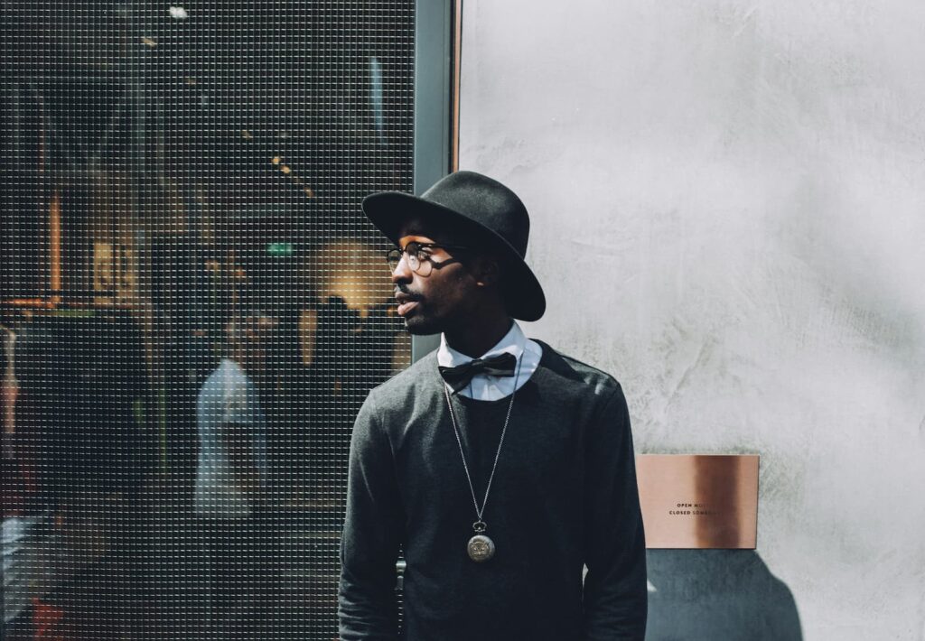 A slim young man standing near the entrance to a performance space