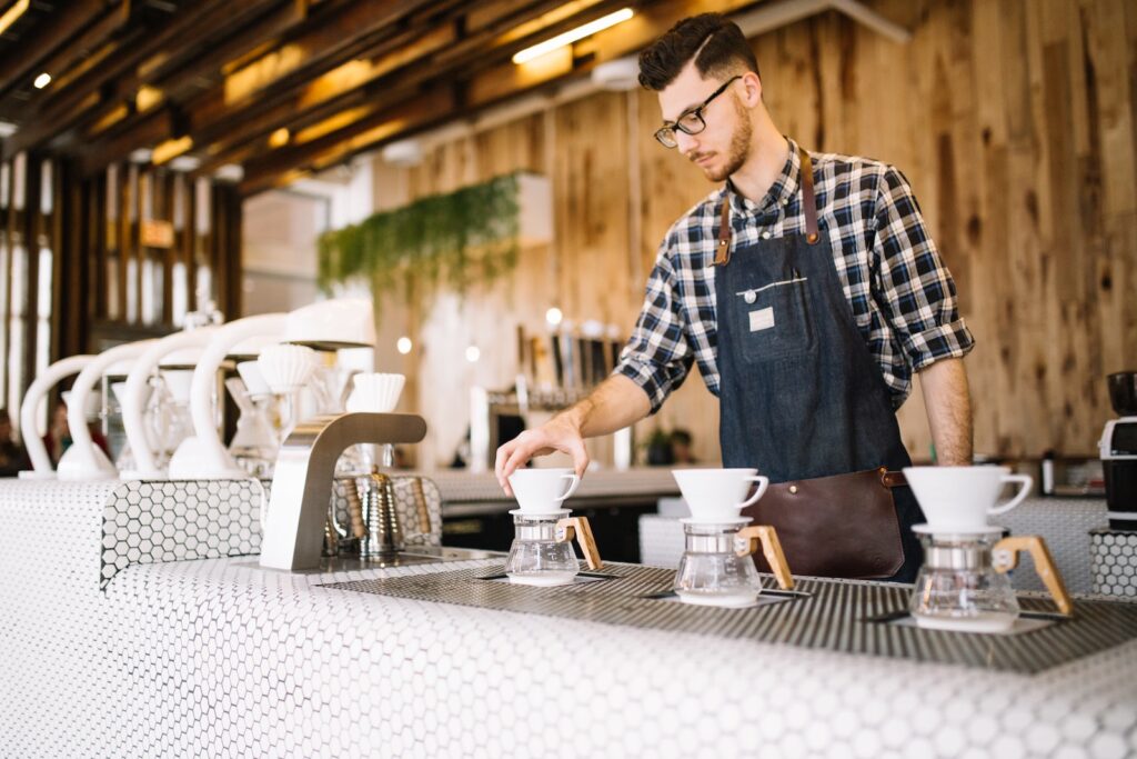 A barista preparing drinks in a coffe shop