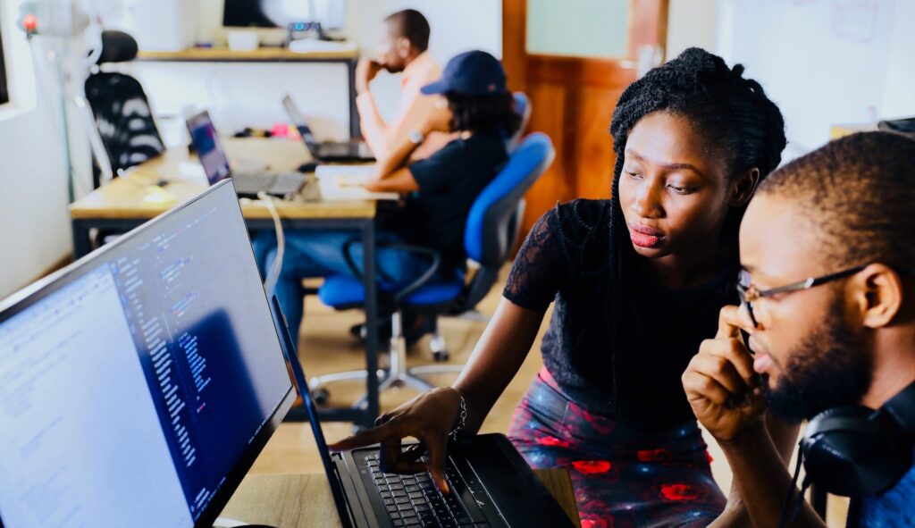 Two office employees working on their computers and getting used to their jobs