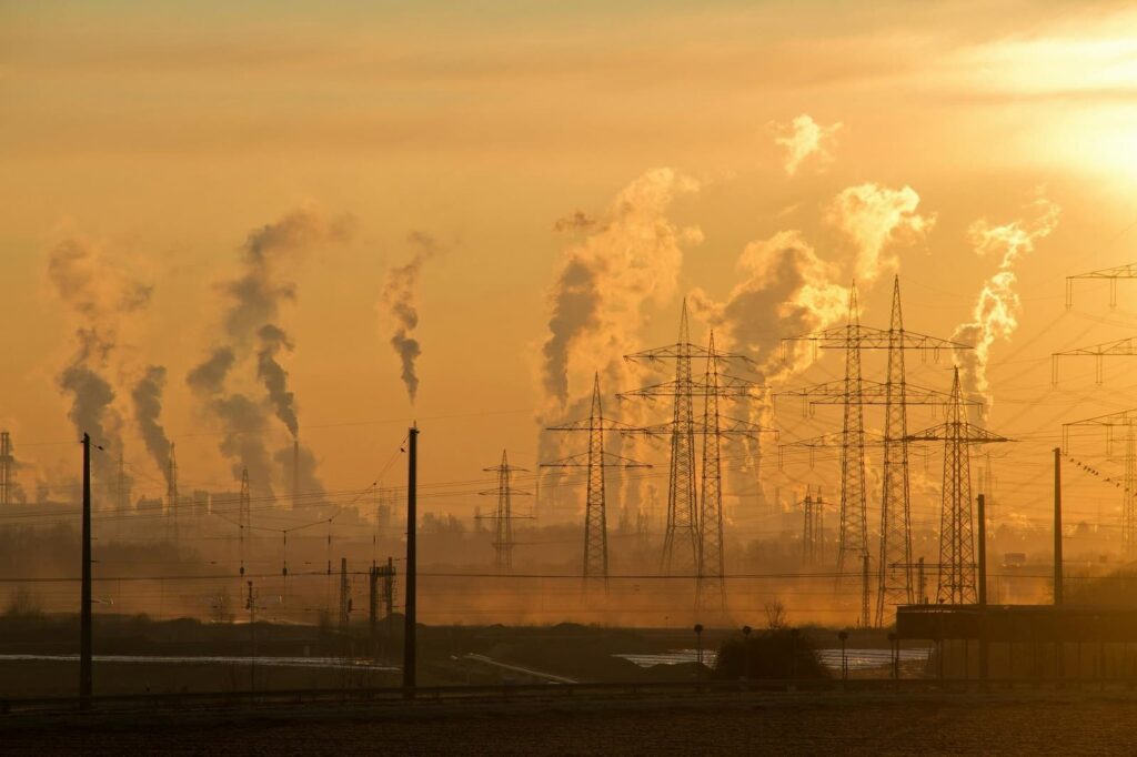 Many factories blowing smoke into sky
