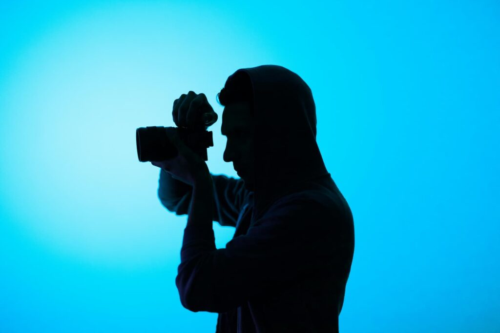 A man holding up a camera and ready to take a picture
