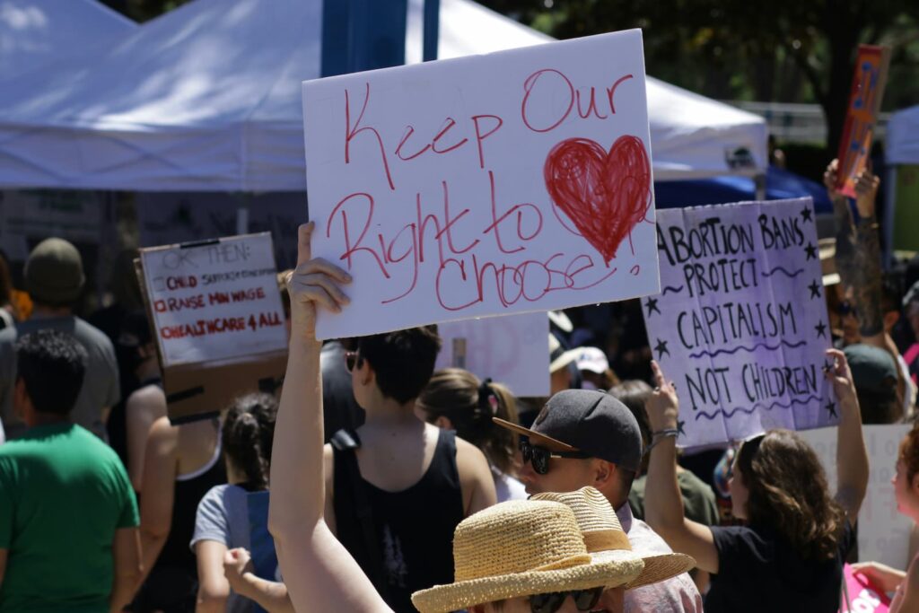 Protesters holding up handmade signs at a demonstration