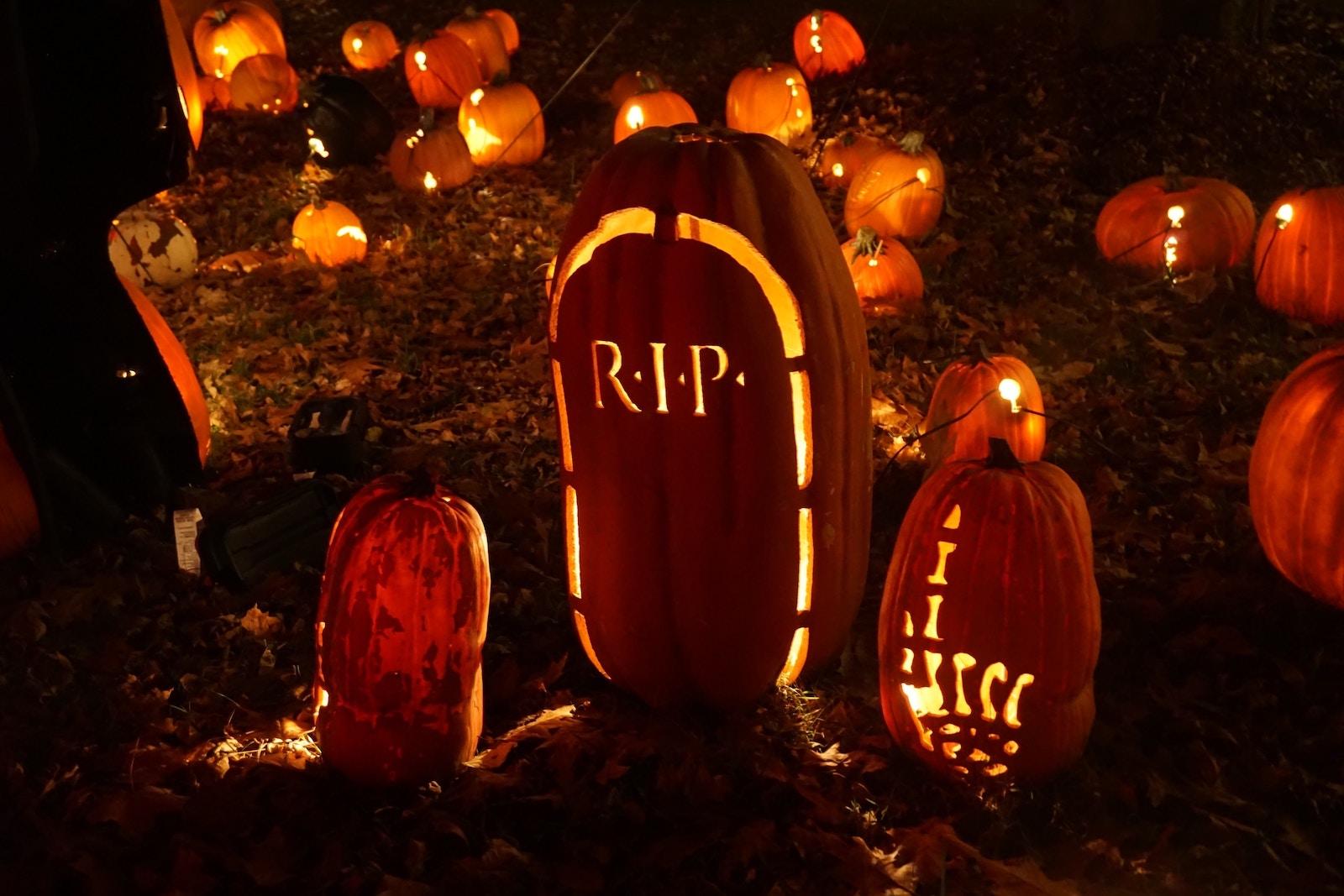Pumpkins of various sizes with lights and Halloween-themed designs