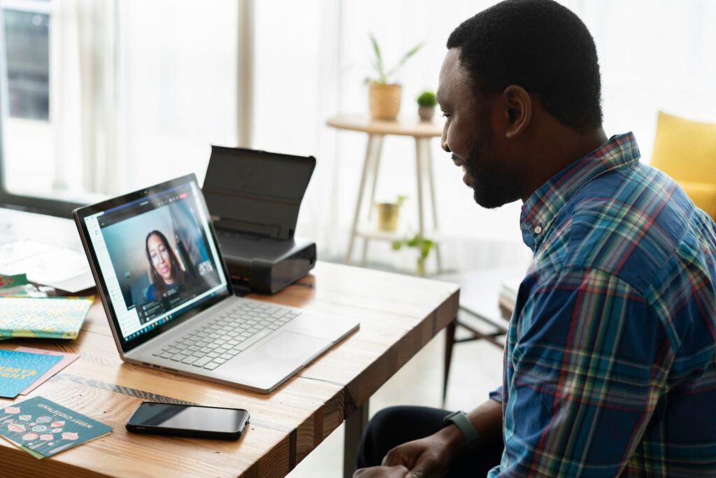 A man having an online class using his laptop