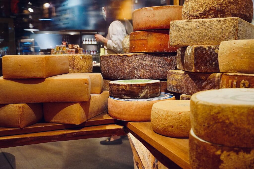 Stacks of wheels of cheese in a store