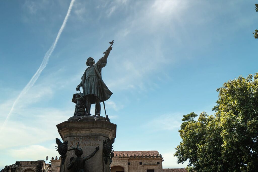 A statue of Christoper Columbus pointing into the distance