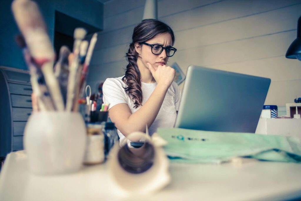 A concerned woman researching an issue on her laptop