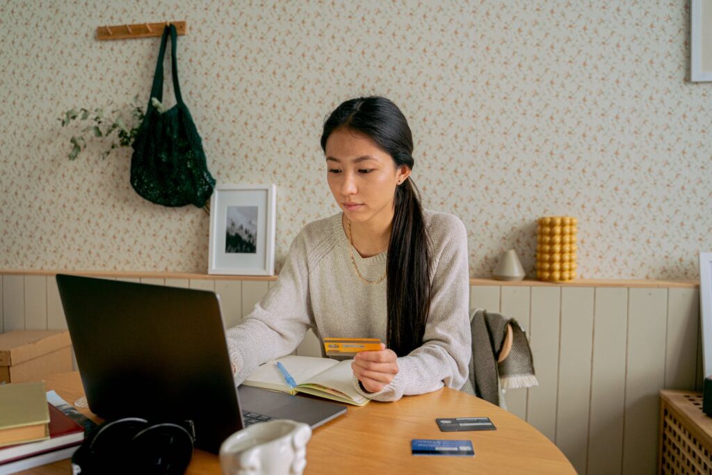 A woman authenticating her credit card while shopping on her computer