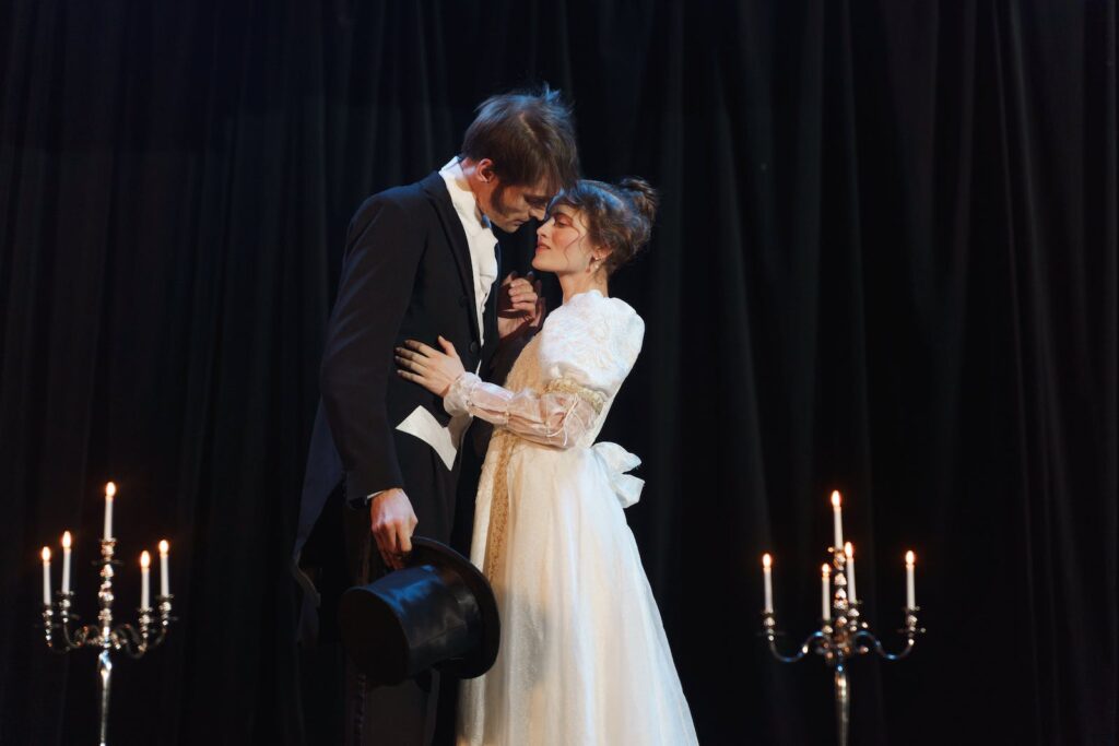 Two actors performing a scene on stage