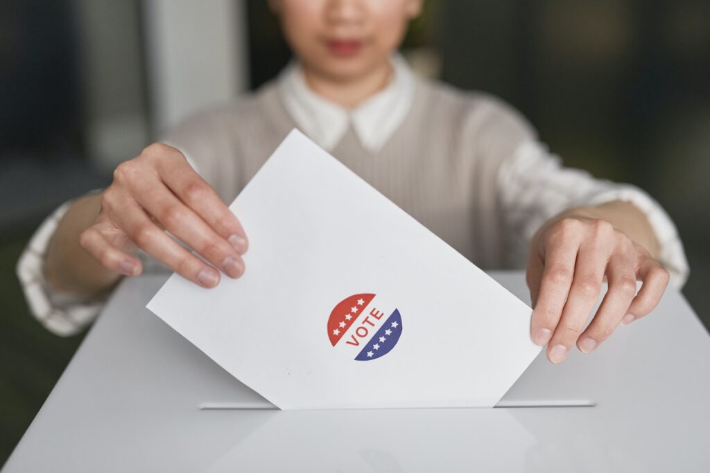 A woman placing a ballot into an election box