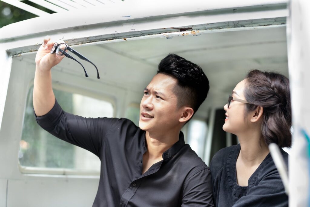 A man raising his eyeglasses and checking his vision