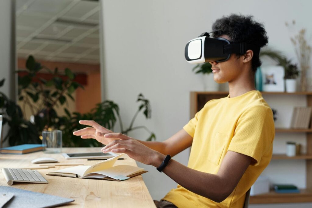 A man wearing a VR headset experiencing virtual reality while sitting at an office desk