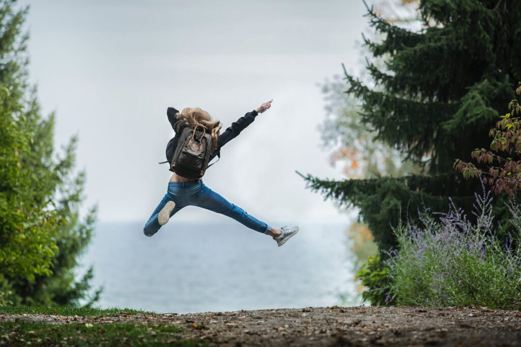 An excited woman jumping into the air