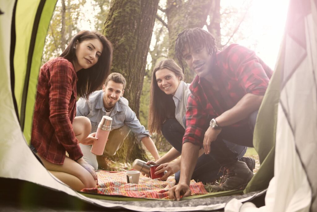 A group of remote work colleagues camping during a retreat