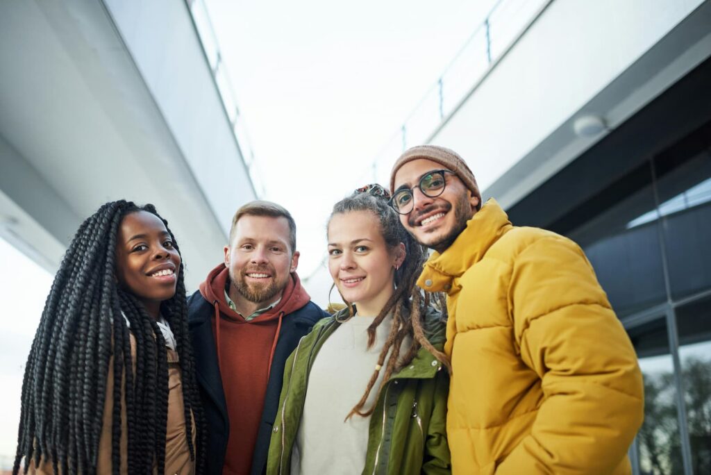 A diverse group of friends smiling while posing for a photo