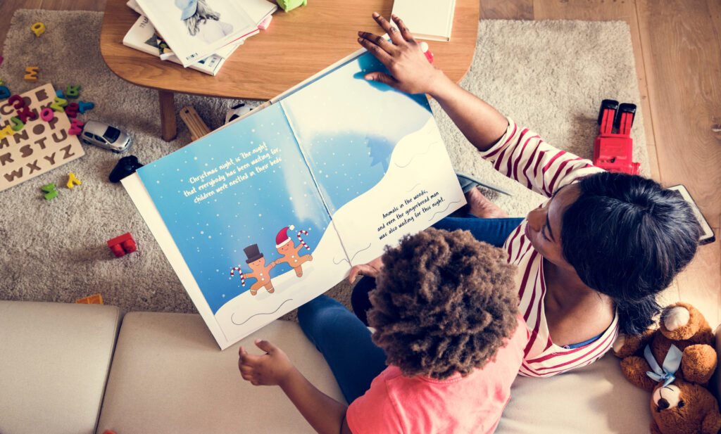 A mother reading an English-language picture book with her son