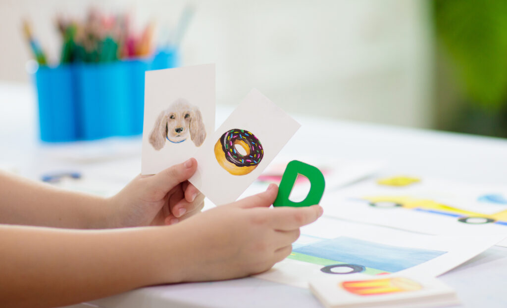 A child learning English by studying with flashcards