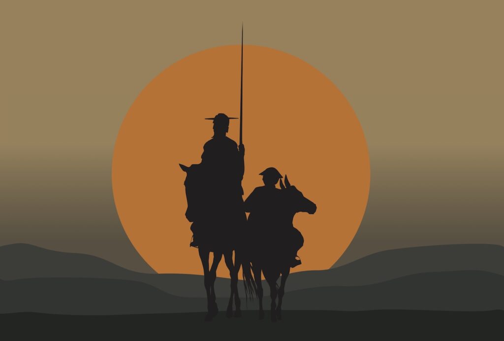 Two silhouettes of men on horseback riding through a desert 