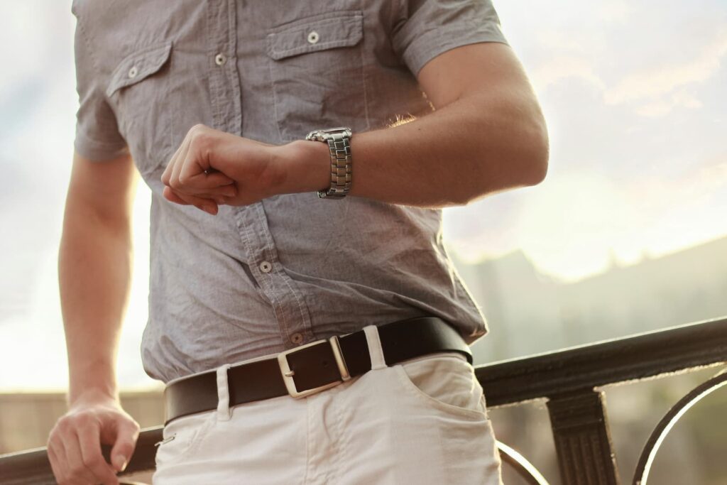 A man checking the time with the watch on his wrist